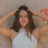 woman in white tank top holding her hair