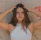 woman in white tank top holding her hair