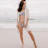 woman in white long sleeve shirt and white panty standing on beach during daytime